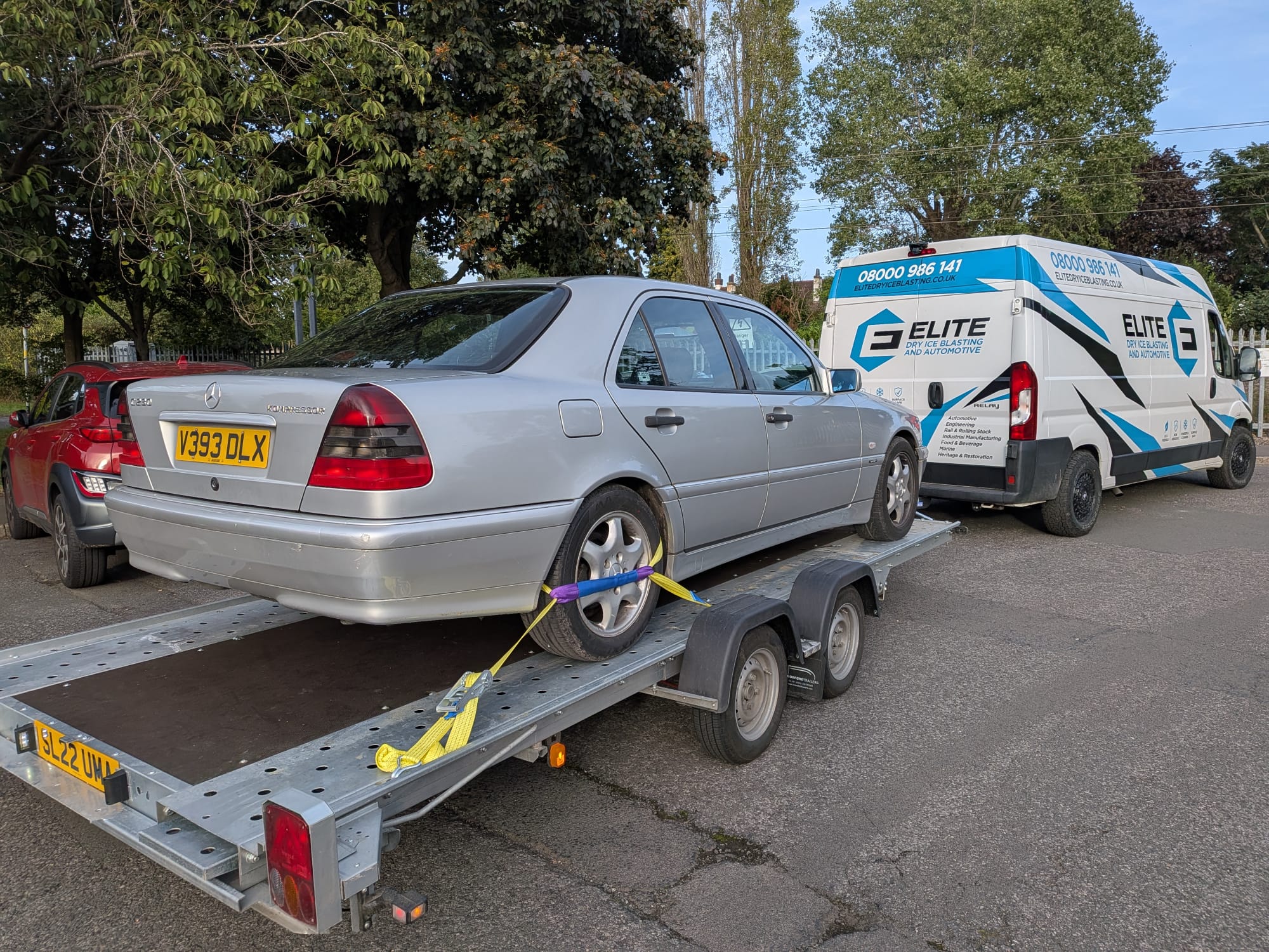 Elite Dry Ice Blasting van and tilt-bed car transport trailer with customer vehicle loaded